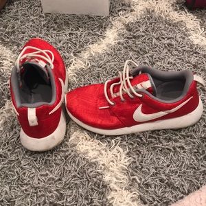 Red and white Nike Roshe Runs